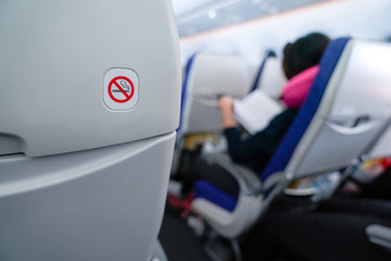 no smoking sign on plane seat.