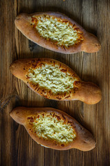 Georgian Khachapuri bread on a wooden background