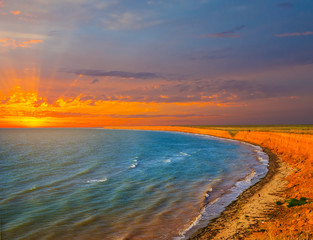 dramatic sea scene, bended sea bay at the sunset