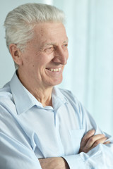Fototapeta na wymiar Portrait of a smiling senior man posing