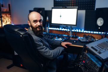 Bearded sound engineer in audio recording studio