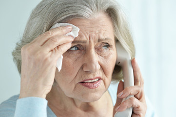 Close up portrait of upset senior woman