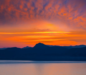 Fototapeta premium red dramatic sunset over the sea bay