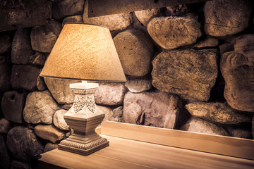 Stone wall and stylish lamp