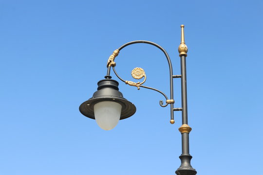 Street lamp post in front of blue sky