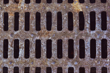 Rusty cast iron drainage hatch close up