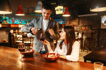 Couple at bar counter, romantic date celebration