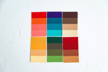 Top view of colorful  felt  swatches on white background. Instrument for color type determination&