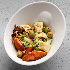 Fresh salad with salmon, cream cheese and olives