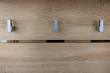 Hooks on a hanger for clothes in the hallway of the house.