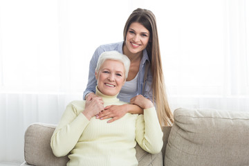 Love you, mom. Young woman hugging mature mother