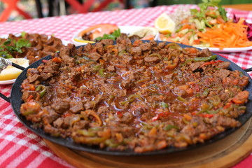 diced lamb fried on iron plate 