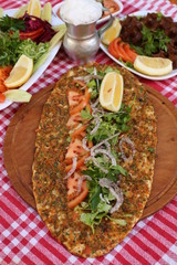 very thin turkish pizza covered with seasoned minced meat and onions 