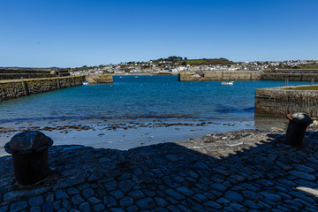 view from the sea over the sea to the land, in the foreground of the cobbled edge of the coast,...
