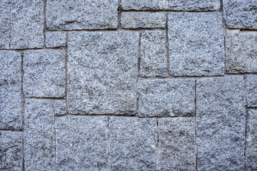 Grey stone polgonal wall with quadrate blocks 