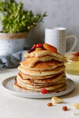 Sweet Homemade Stack of Pancakes with  honey for Breakfast  on a gray background. Sweet beautiful breakfast. Brunch. Family Breakfast. Concept for cafes, restaurants, fast food outlets, bars