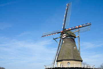 Spring landscape with traditional Dutch windmill in Brabant