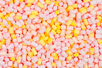 Marshmallow. Background of pink and yellow colorful mini marshmallows.