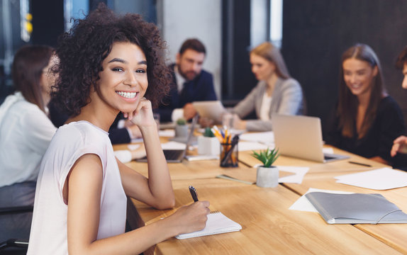 African-american Businesswoman Smiling At Camera At Meeting