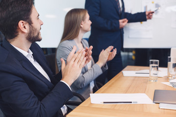 Businessman applauding to reporter after listening presentation