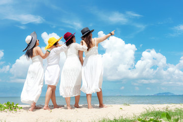 Group family asian woman wearing fashion white dress summer standing the sandy sea beach, outdoors...