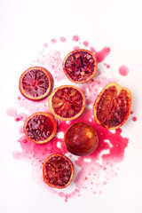 Squeezed Sliced Ripe Juicy Sicilian Blood Oranges on White Background Tasty Oranges Wooden Squeezer...