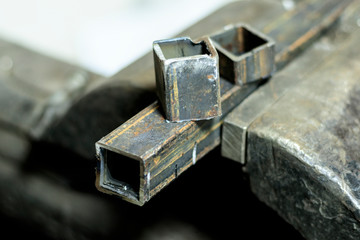 metal clutches in them clamped square tube. there is still a piece on top. shallow depth of cut.