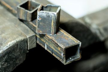 metal clutches in them clamped square tube. there is still a piece on top. shallow depth of cut.