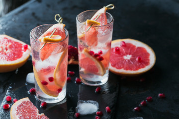 Grapefruit and pomegranate cocktail or mocktail, refreshing summer drink with crushed ice