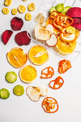 Dried vegetables and fruits on a white background, top view.