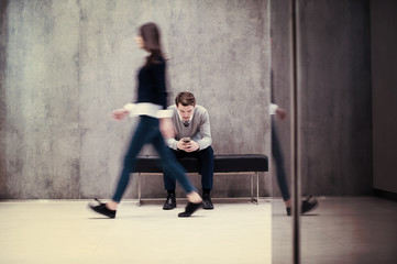 businessman using mobile phone while sitting on the bench