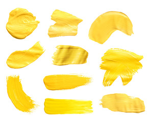 Naklejka premium Set with abstract brushstrokes of yellow paint on white background, top view