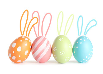 Set of colorful eggs with Easter bunny ears on white background