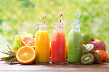Fotobehang bottles of fruit juice and smoothie with fresh fruits © Nitr