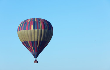 Beautiful view of hot air balloon in blue sky. Space for text