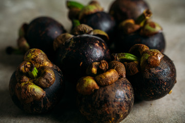 Fresh mangostine. Fresh Tropical Fruits. On a grey background. Top view.