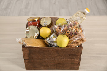 Donation box with food on table indoors