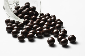 Tasty chocolate balls in pot isolated on a white background