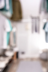 Blurred view of modern dressing room with stylish clothes