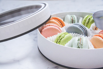 French sweets dessert-Macarons, multicolored, in a gift box with a ribbon