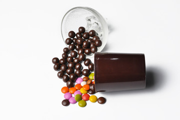 Tasty chocolate balls in pot isolated on a white background