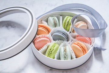 French sweets dessert-Macarons, multicolored, in a gift box with a ribbon