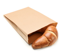 Paper bag with croissant on white background. Space for design