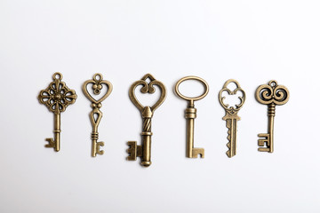 Bronze vintage ornate keys on white background, top view