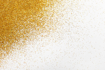 Golden glitter on white background, top view