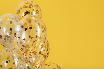 Balloons with sparkles on color background. Space for text