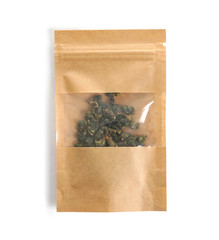Craft paper bag with Tie Guan Yin Oolong tea on white background, top view