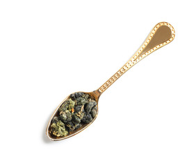 Spoon with Tie Guan Yin Oolong tea on white background, top view