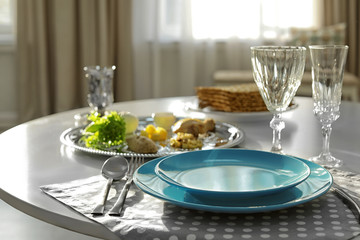 Table served for Passover (Pesach) Seder indoors, space for text
