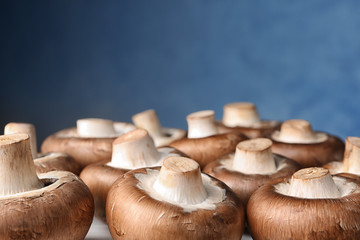 Fresh champignon mushrooms on color background, closeup. Space for text